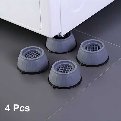 Four gray rubber furniture glides on a floor with a white piece of furniture.